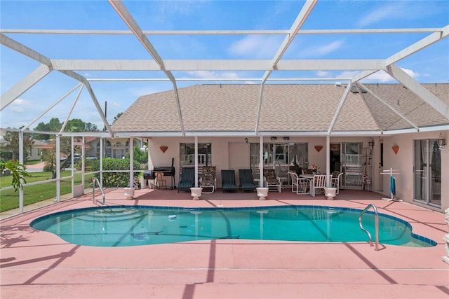 view of swimming pool featuring a grill, a patio area, and glass enclosure