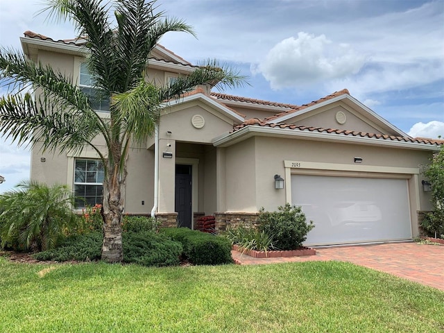 mediterranean / spanish-style house with a front lawn and a garage