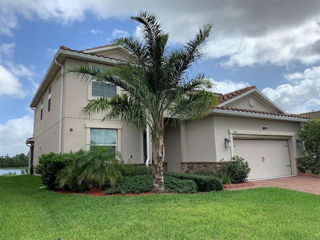 view of front of home with a front lawn and a garage