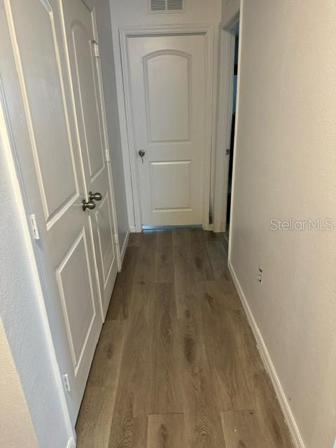 hallway with light hardwood / wood-style flooring