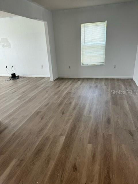 unfurnished room with hardwood / wood-style flooring