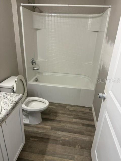 full bathroom with hardwood / wood-style floors, vanity, toilet, and bathtub / shower combination