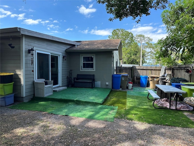 rear view of house with a yard