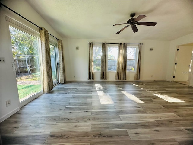 unfurnished room with ceiling fan and light wood-type flooring