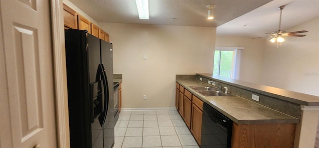 kitchen featuring kitchen peninsula, ceiling fan, sink, black appliances, and light tile patterned flooring