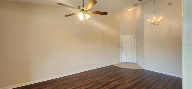 unfurnished room with hardwood / wood-style floors and ceiling fan with notable chandelier