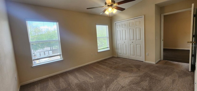 unfurnished bedroom featuring carpet, ceiling fan, a closet, and vaulted ceiling