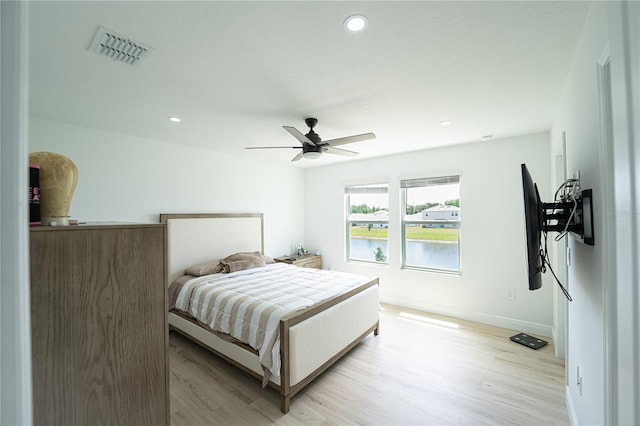 bedroom featuring ceiling fan and light hardwood / wood-style flooring