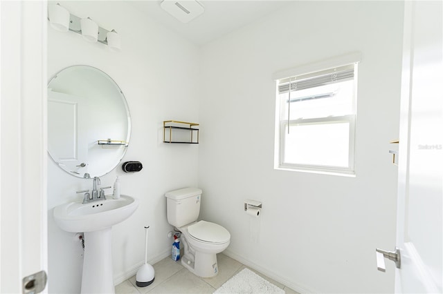 bathroom featuring toilet and tile floors