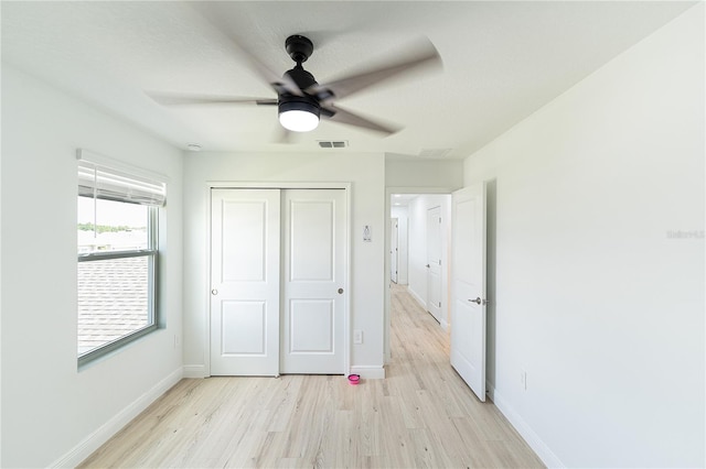 unfurnished bedroom featuring a closet, ceiling fan, and light hardwood / wood-style floors