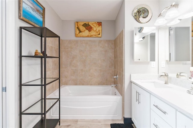 bathroom featuring vanity, a bath, and hardwood / wood-style floors