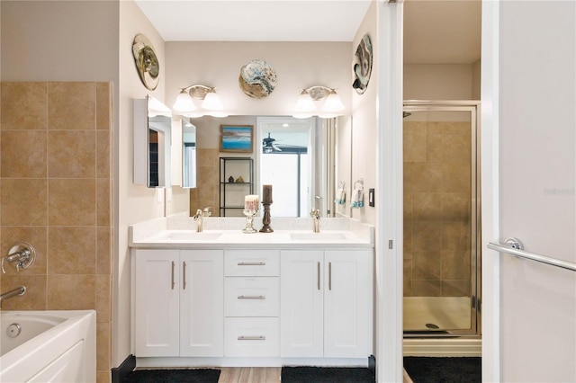 bathroom with vanity and separate shower and tub