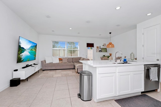 kitchen with decorative light fixtures, white cabinetry, stainless steel dishwasher, sink, and light tile floors