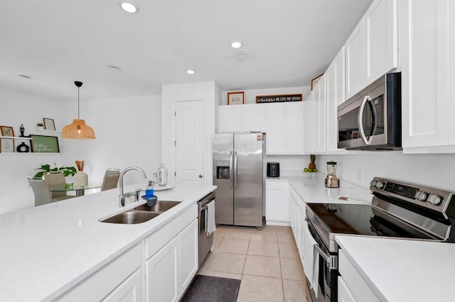 kitchen featuring white cabinetry, appliances with stainless steel finishes, decorative light fixtures, sink, and light tile flooring