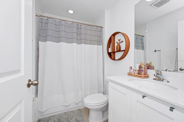 bathroom with tile flooring, toilet, and large vanity