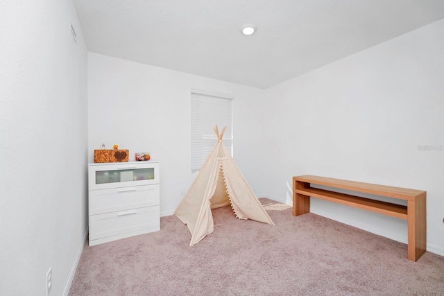 recreation room with light carpet