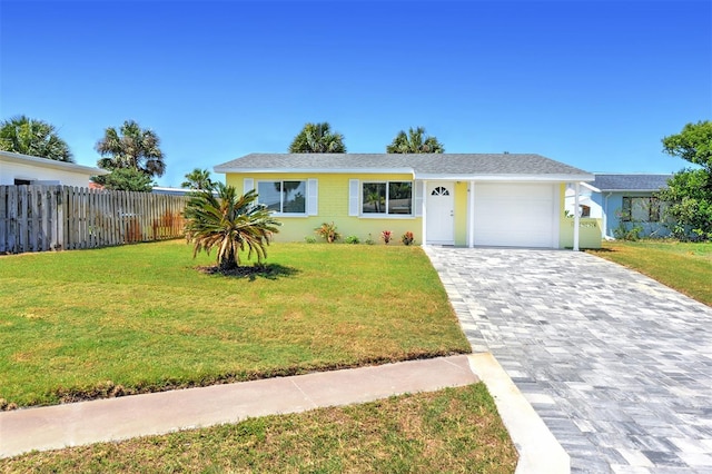 view of front of property featuring a garage and a front lawn