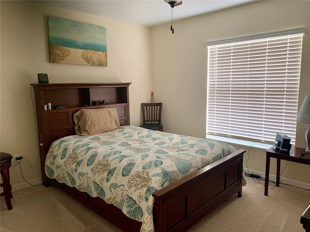 bedroom featuring light colored carpet and ceiling fan