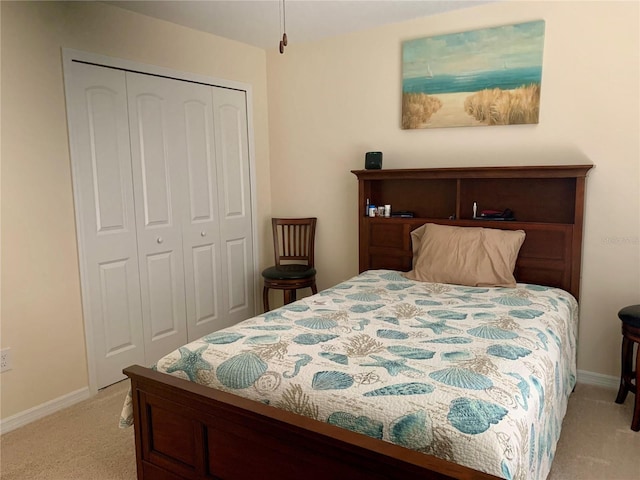 bedroom featuring light carpet and a closet