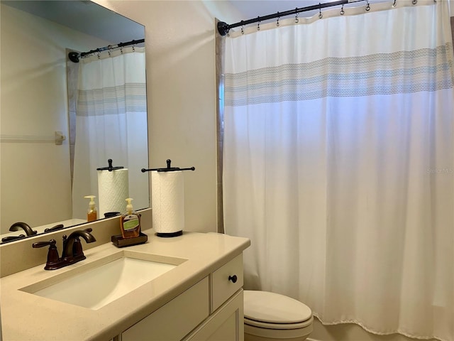 bathroom featuring vanity, a shower with shower curtain, and toilet