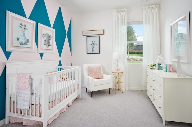 bedroom with light colored carpet and a crib