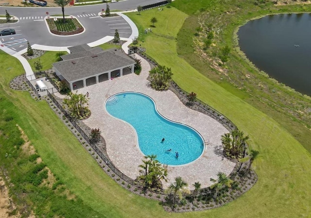 pool featuring a water view and a patio area