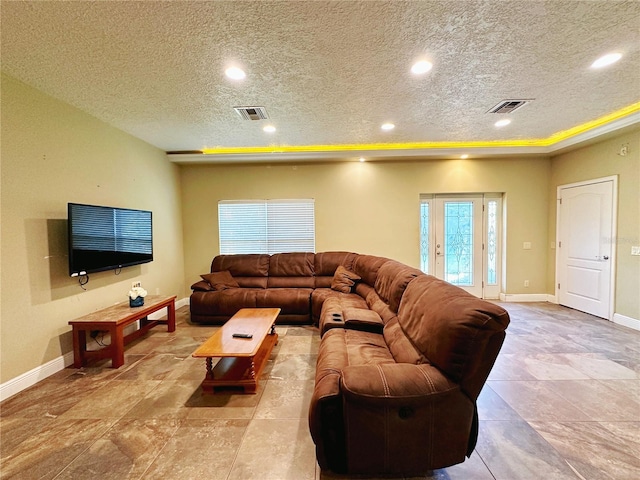 tiled living room with a textured ceiling