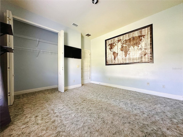 unfurnished bedroom featuring carpet and a closet