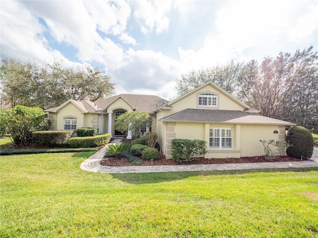 single story home featuring a front lawn