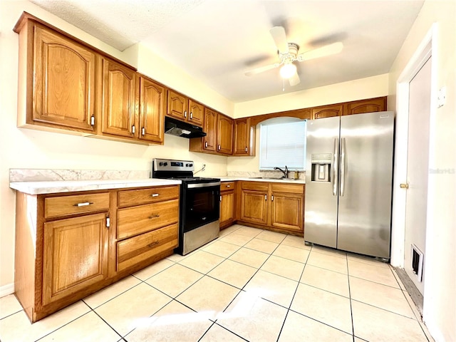 kitchen with sink, ceiling fan, appliances with stainless steel finishes, and light tile patterned floors