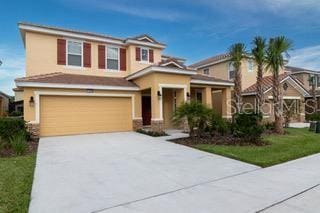 view of front of house with a garage and a front lawn