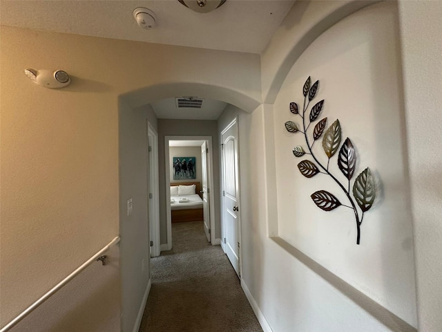 corridor with dark colored carpet