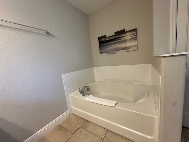 bathroom with a tub to relax in and tile patterned floors