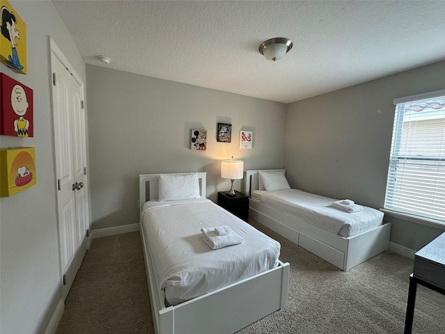 bedroom with carpet floors and a textured ceiling