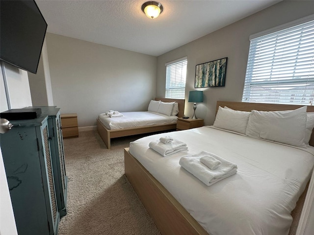 bedroom featuring carpet floors and a textured ceiling