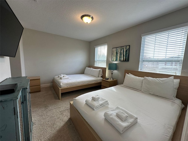 carpeted bedroom with a textured ceiling