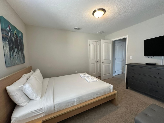 bedroom with carpet floors, a closet, and a textured ceiling