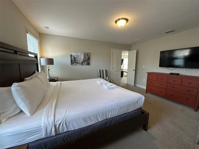 carpeted bedroom featuring a textured ceiling