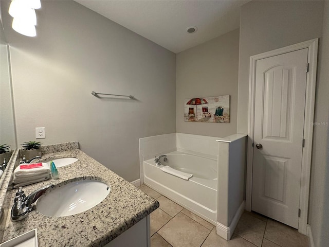 bathroom featuring a tub to relax in, tile patterned floors, and vanity