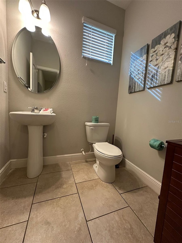 bathroom featuring tile patterned flooring and toilet