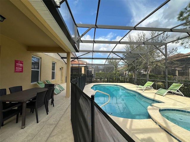 view of pool featuring a patio, glass enclosure, and an in ground hot tub