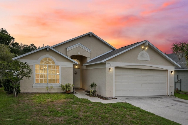 view of front of property with a lawn and a garage