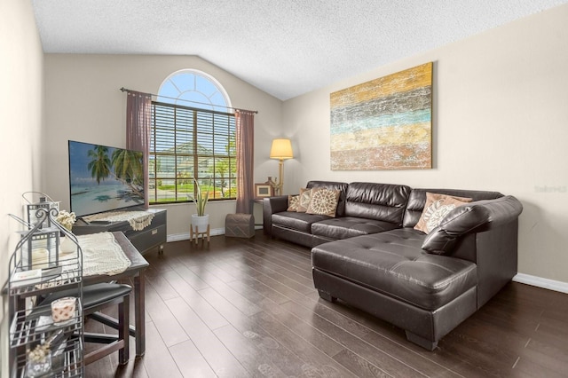 living room featuring a textured ceiling, dark wood-type flooring, and vaulted ceiling