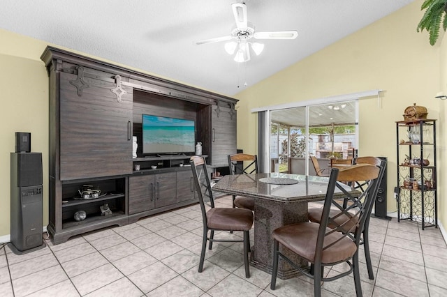 tiled dining area featuring ceiling fan, lofted ceiling, and a textured ceiling