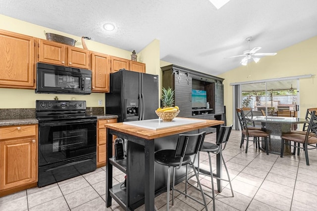 kitchen featuring light tile patterned floors, a textured ceiling, ceiling fan, and black appliances