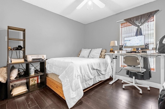 bedroom featuring dark hardwood / wood-style flooring, a textured ceiling, and ceiling fan