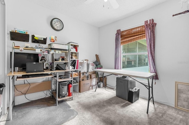 carpeted home office featuring a textured ceiling and ceiling fan