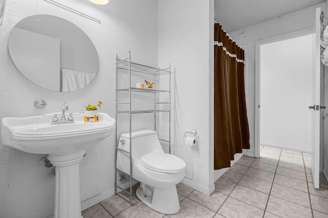 bathroom featuring toilet and tile patterned floors