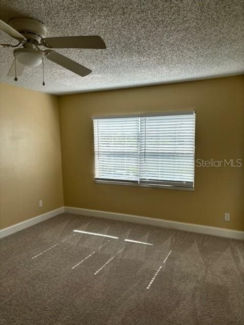 spare room featuring carpet flooring, a textured ceiling, and ceiling fan