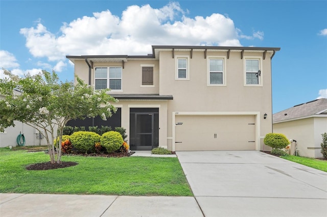 view of front of home featuring a front yard and a garage